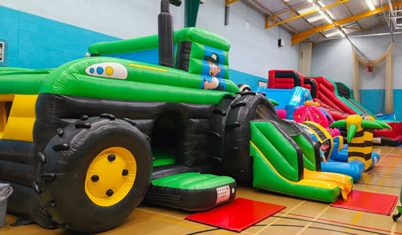 Children enjoying inflatable fun day in Carmarthenshire