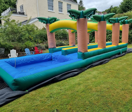 Palm Tree Slip ’n Slide double lane water slide set up for an event in Swansea
